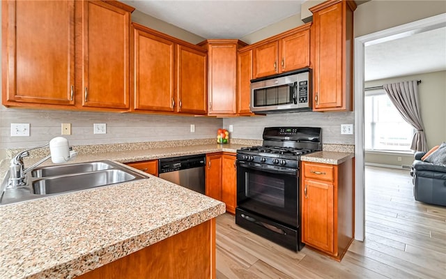 kitchen featuring a sink, decorative backsplash, light countertops, appliances with stainless steel finishes, and brown cabinets