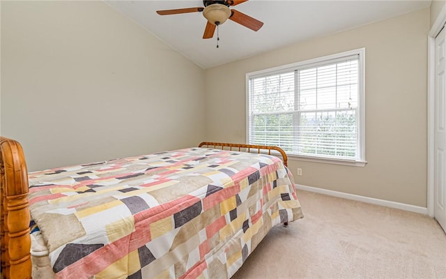 bedroom featuring light carpet, a ceiling fan, lofted ceiling, and baseboards