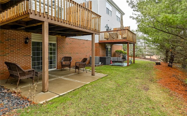 view of yard featuring a deck, cooling unit, and a patio