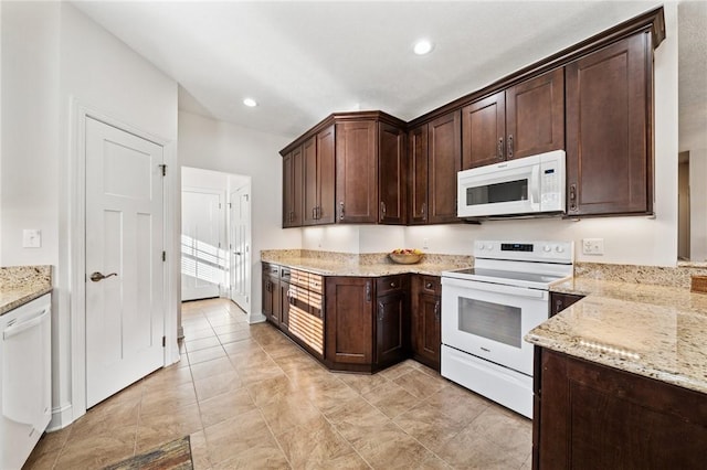 kitchen with light stone counters, recessed lighting, dark brown cabinets, and white appliances