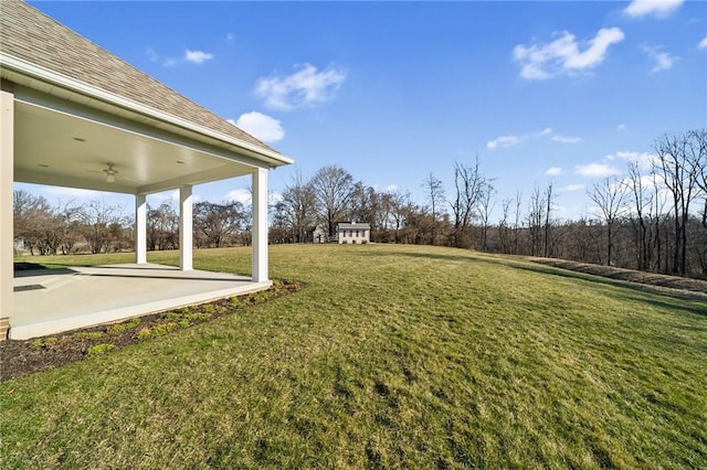 view of yard with a patio and ceiling fan