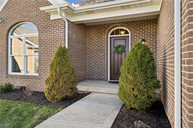 doorway to property with brick siding