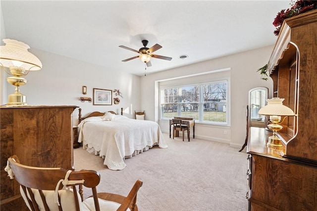 bedroom with baseboards, light carpet, and visible vents