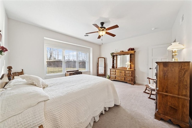 bedroom with baseboards, light carpet, visible vents, and ceiling fan