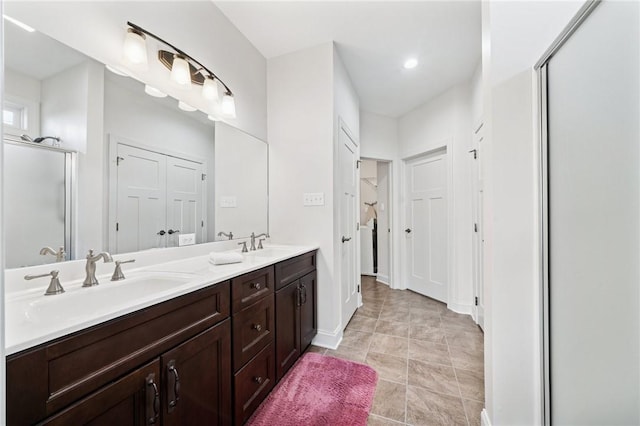 full bathroom featuring a sink, a closet, an enclosed shower, and double vanity