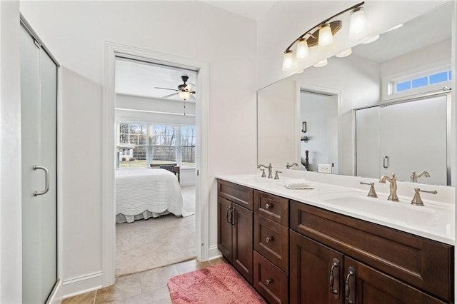 full bathroom featuring double vanity, a stall shower, and a sink