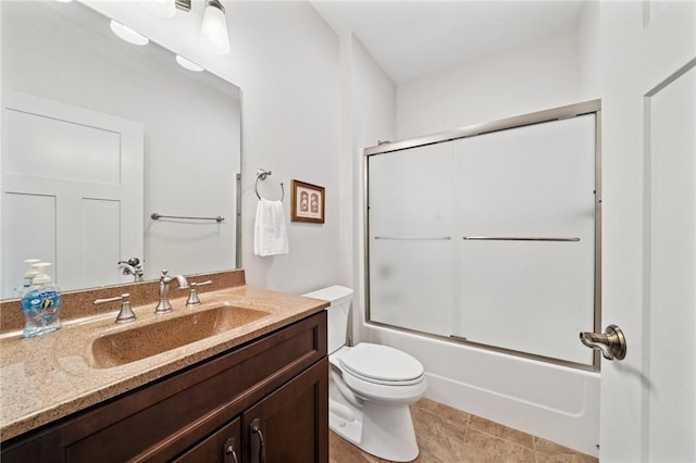 full bathroom featuring toilet, vanity, and bath / shower combo with glass door