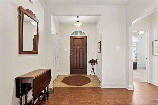 entrance foyer featuring baseboards and wood finished floors