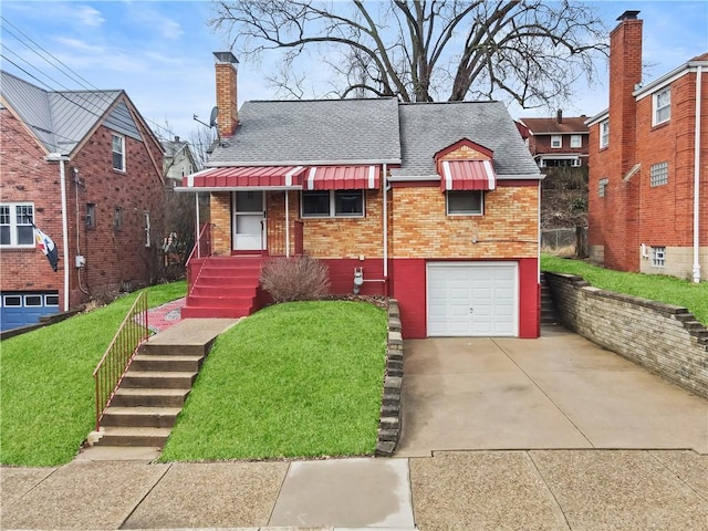 view of front of property featuring a shingled roof, concrete driveway, a front yard, an attached garage, and brick siding