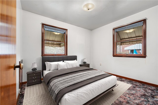 carpeted bedroom featuring baseboards