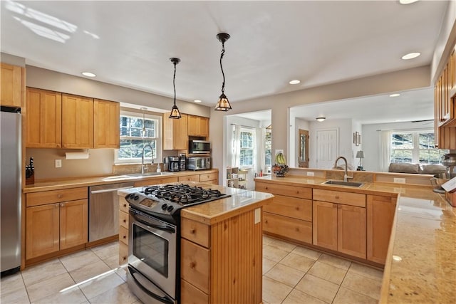 kitchen featuring stainless steel appliances, light countertops, and a sink