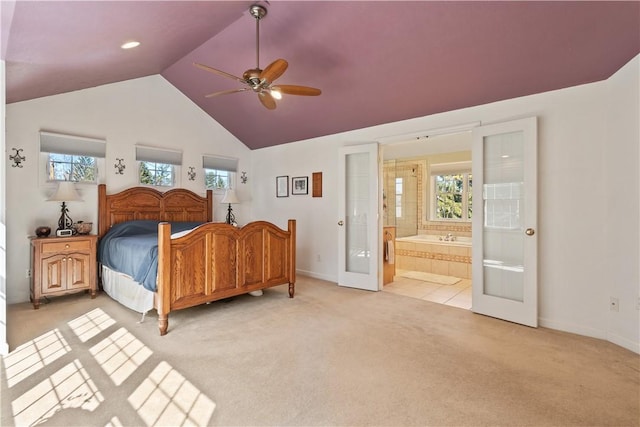 bedroom with ensuite bath, french doors, baseboards, lofted ceiling, and light colored carpet