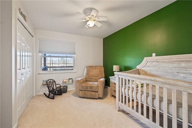 carpeted bedroom featuring a closet, a ceiling fan, and baseboards