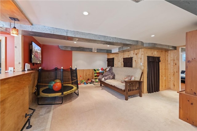 living room with recessed lighting, wood walls, and carpet flooring