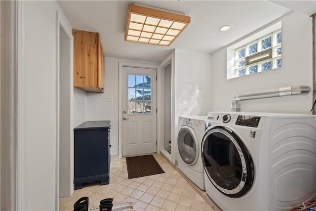 laundry room featuring washer and clothes dryer, plenty of natural light, cabinet space, and recessed lighting