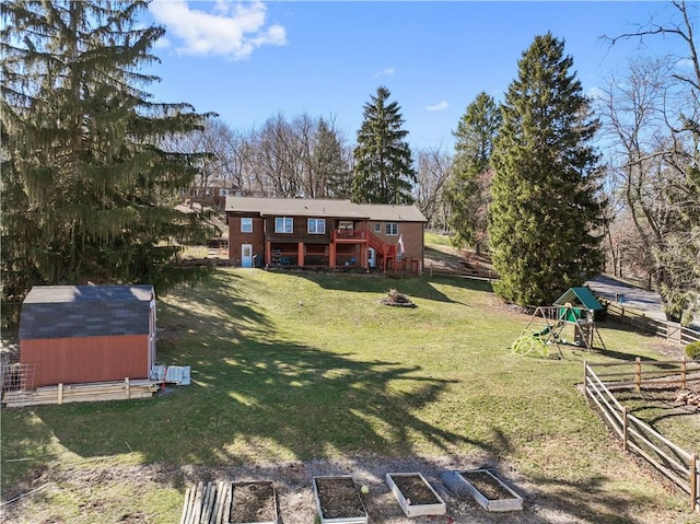 exterior space featuring a shed, stairway, an outdoor structure, and fence