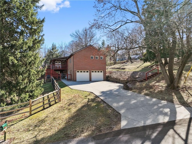 view of front of property featuring a garage, fence, brick siding, and driveway