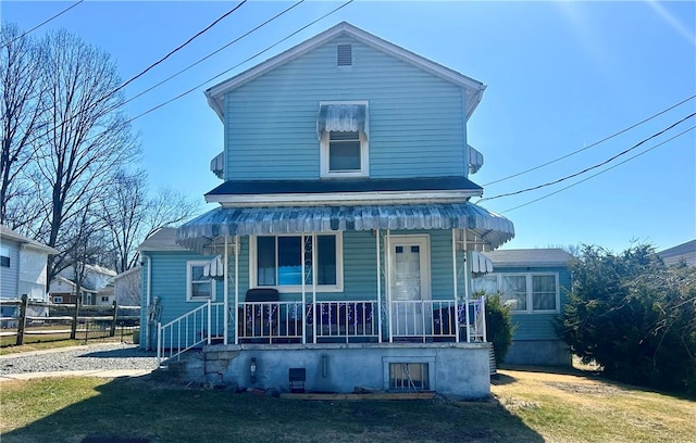 view of front facade with a porch and fence