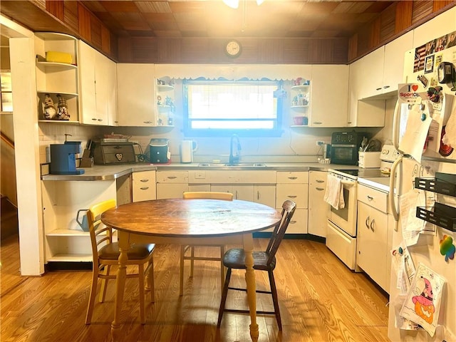 kitchen with open shelves, white appliances, white cabinets, and a sink