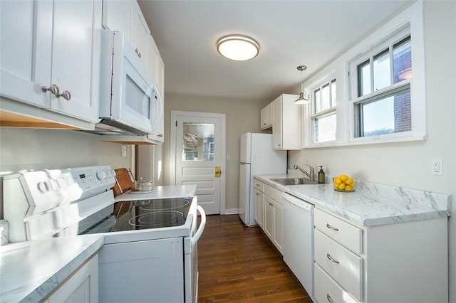 kitchen featuring white cabinets, white appliances, light countertops, and a sink