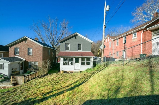 back of property featuring a lawn