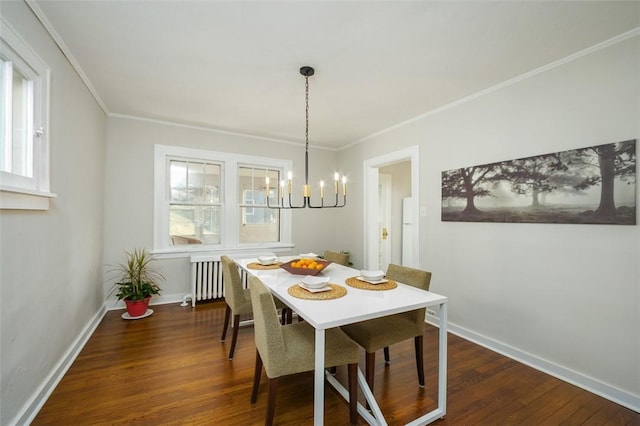 dining space featuring baseboards, an inviting chandelier, radiator heating unit, dark wood-style flooring, and ornamental molding