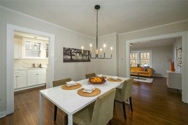 dining room with dark wood finished floors, baseboards, and ornamental molding