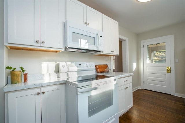 kitchen with white appliances, white cabinets, and dark wood-style flooring