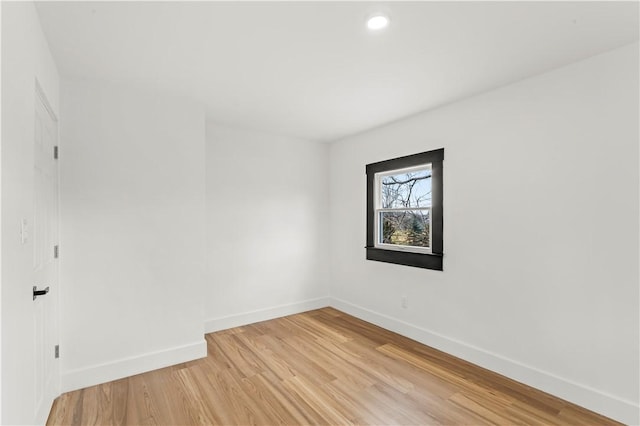 spare room featuring recessed lighting, baseboards, and light wood-style floors