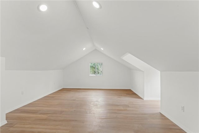 additional living space featuring vaulted ceiling, recessed lighting, baseboards, and light wood finished floors