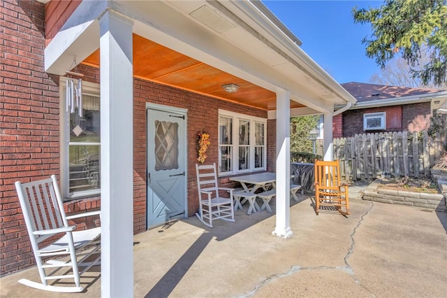 view of patio with covered porch and fence