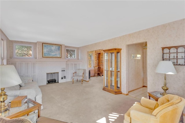 carpeted living room with a fireplace and wallpapered walls