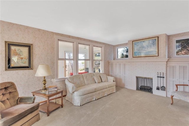 living room featuring wallpapered walls, a brick fireplace, and carpet floors