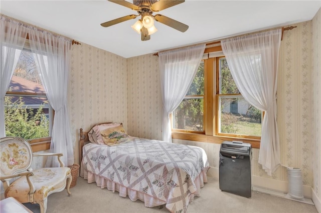 bedroom with multiple windows, wallpapered walls, and carpet