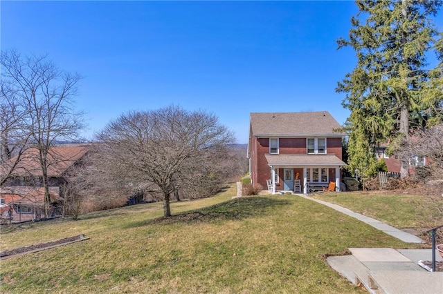 back of property with a yard and covered porch