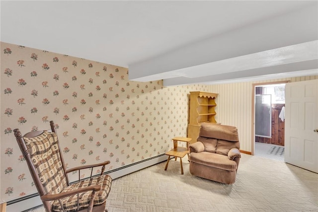 sitting room with a baseboard radiator, light colored carpet, and wallpapered walls