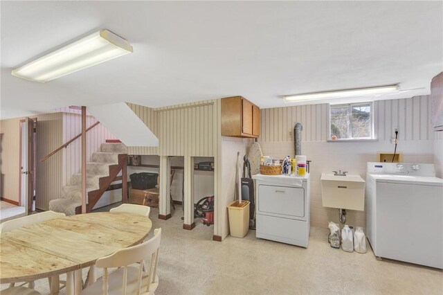 interior space featuring washing machine and dryer, cabinet space, and a sink