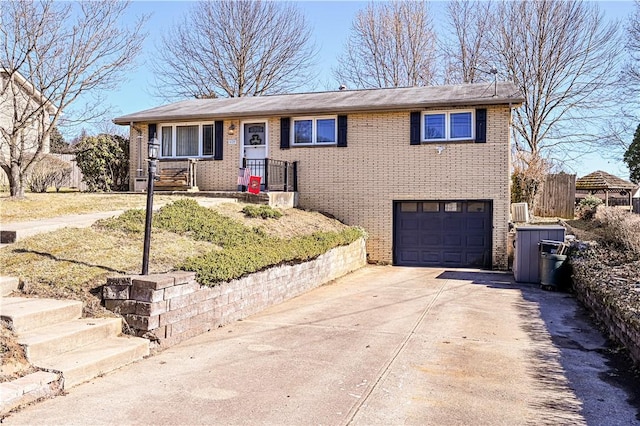 ranch-style home with a garage, brick siding, and concrete driveway