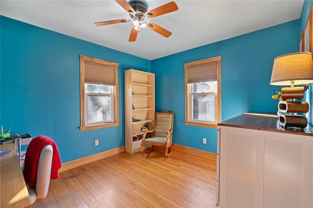 office area featuring hardwood / wood-style floors, a healthy amount of sunlight, baseboards, and ceiling fan