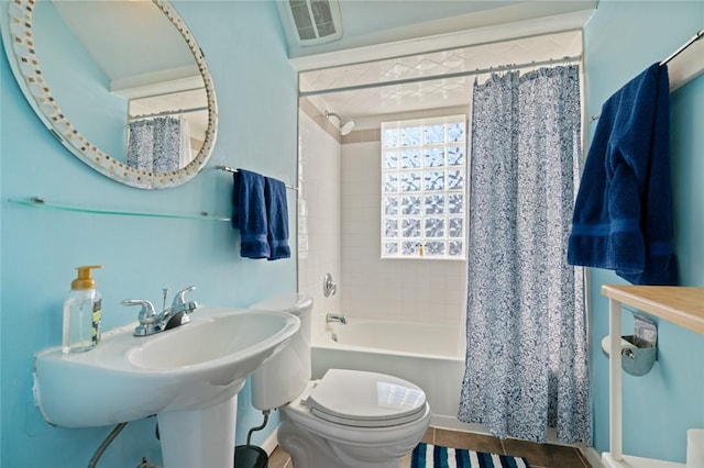 bathroom with a sink, visible vents, shower / bathtub combination with curtain, and toilet