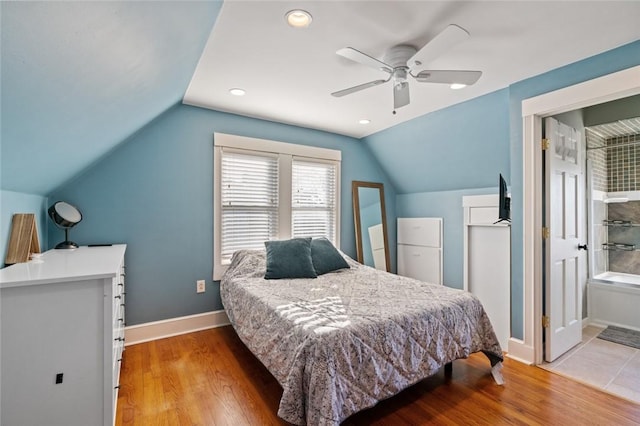 bedroom with wood finished floors, recessed lighting, baseboards, ceiling fan, and vaulted ceiling