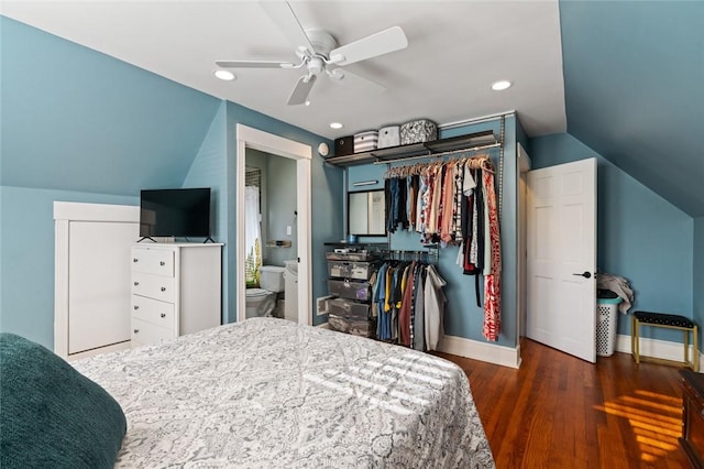 bedroom with baseboards, lofted ceiling, recessed lighting, wood finished floors, and a closet