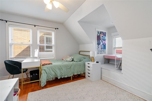 bedroom with vaulted ceiling, wood finished floors, and ceiling fan