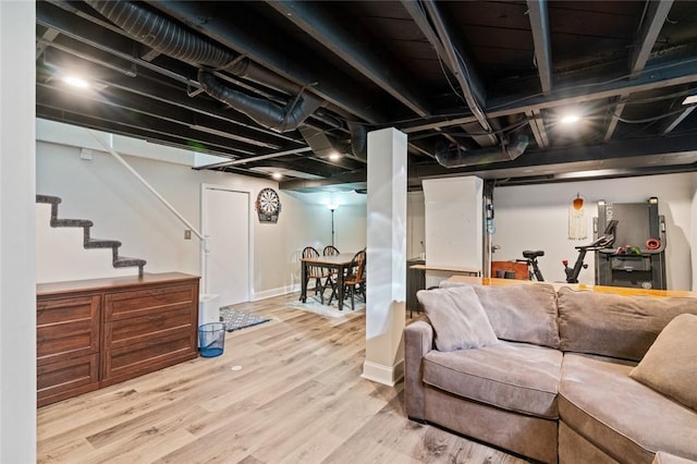 interior space featuring stairway, baseboards, and wood finished floors