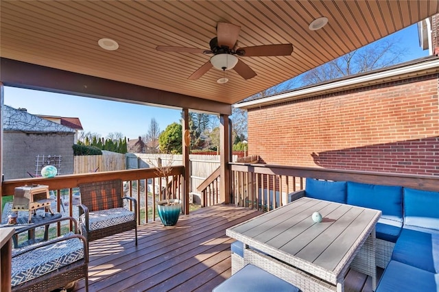 deck featuring ceiling fan and fence