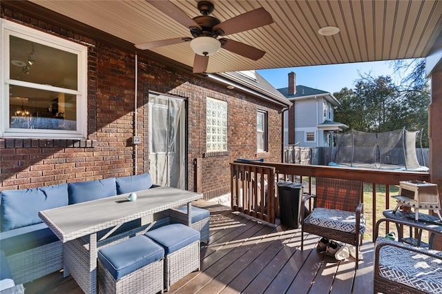 deck featuring outdoor lounge area, a trampoline, and ceiling fan