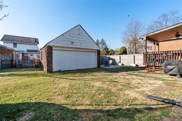 view of yard featuring an outbuilding, a garage, and a fenced backyard