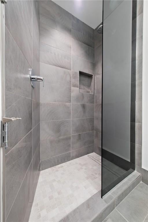 bathroom with tiled shower