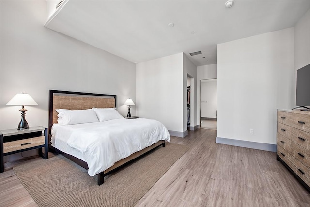 bedroom with wood finished floors and baseboards