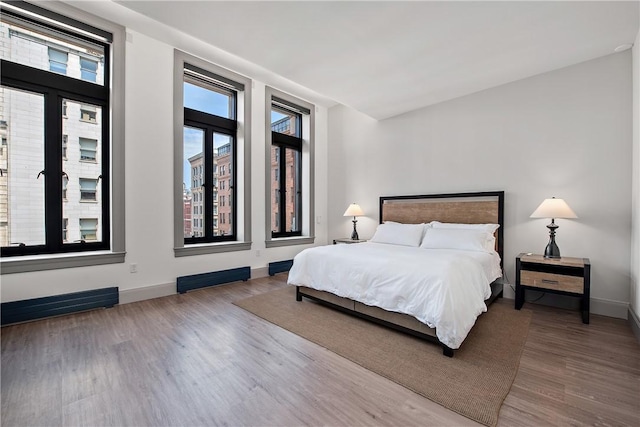 bedroom featuring wood finished floors and baseboards